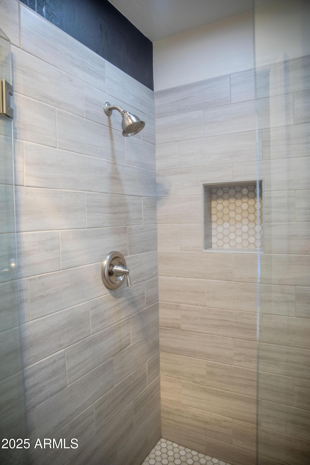 full bath with a tile shower