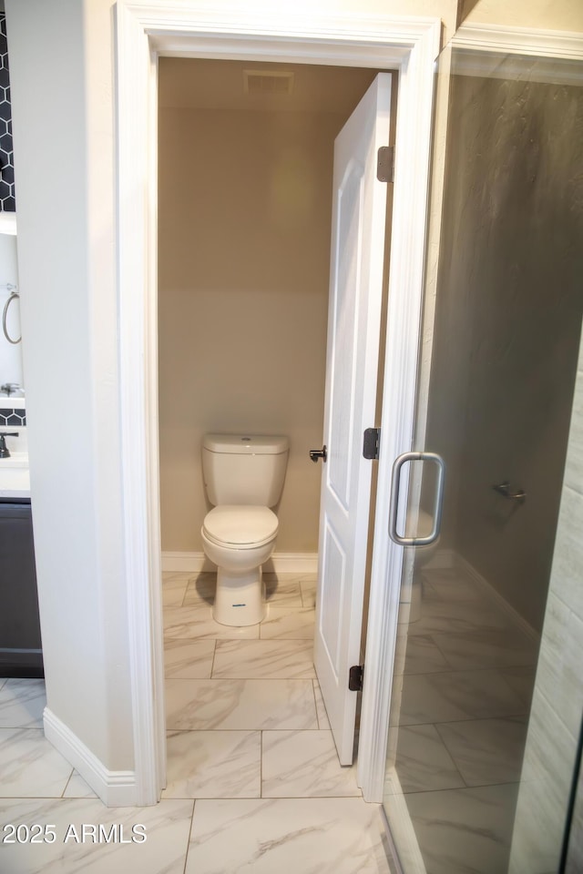 bathroom featuring marble finish floor, visible vents, baseboards, and toilet