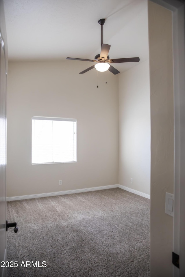 carpeted empty room with a ceiling fan and baseboards