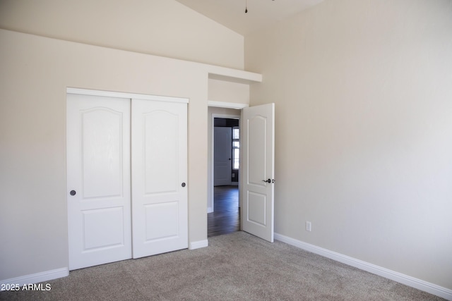 unfurnished bedroom with a closet, carpet flooring, and baseboards