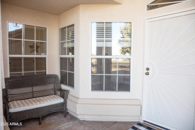 doorway to property featuring stucco siding