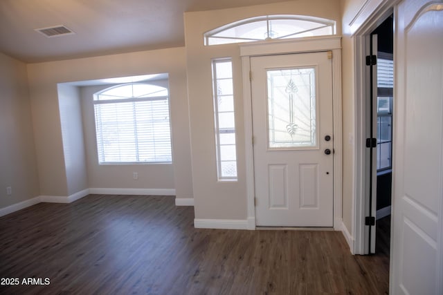 foyer with wood finished floors, visible vents, and baseboards