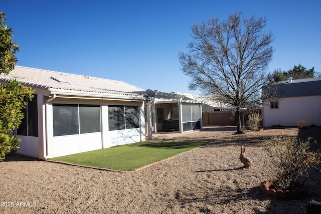 back of property featuring a tiled roof, fence, a yard, a patio area, and a pergola