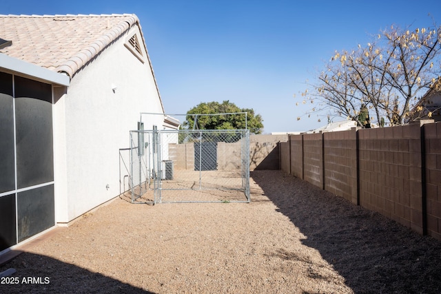 view of yard featuring a fenced backyard and central AC