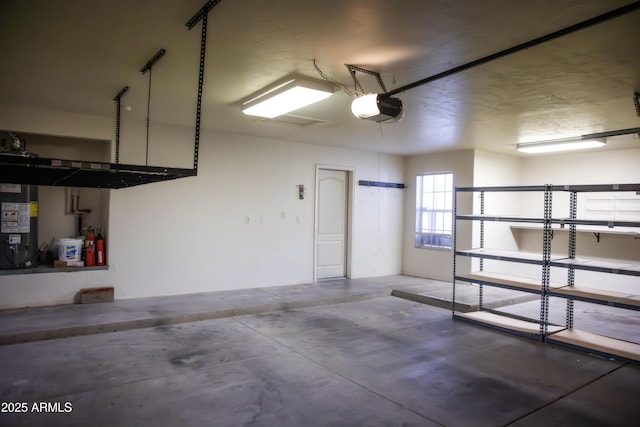 garage with gas water heater and a garage door opener