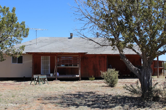 rear view of house featuring a wooden deck