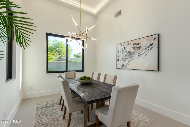 dining area featuring a high ceiling and an inviting chandelier