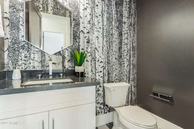 bathroom featuring vanity and toilet