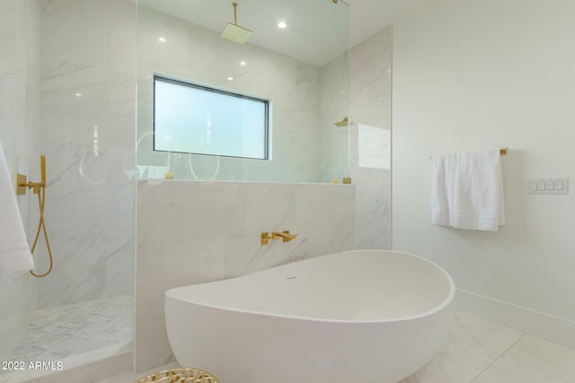 bathroom featuring separate shower and tub and tile walls