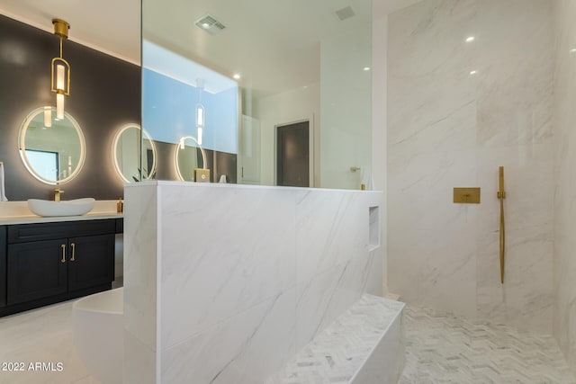 bathroom featuring a tile shower, tile patterned floors, and vanity