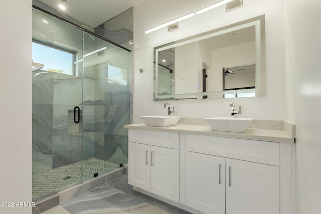 bathroom featuring vanity and a shower with shower door