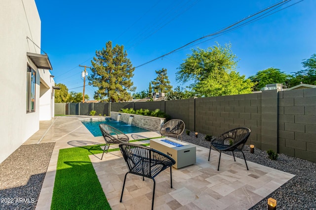 view of patio featuring pool water feature, a fenced in pool, and a fire pit