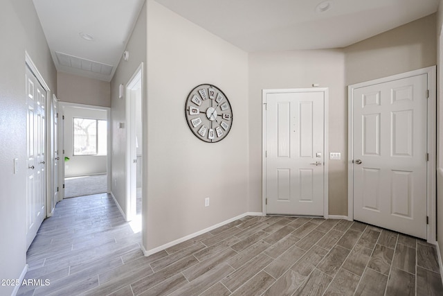 hallway featuring wood finish floors and baseboards