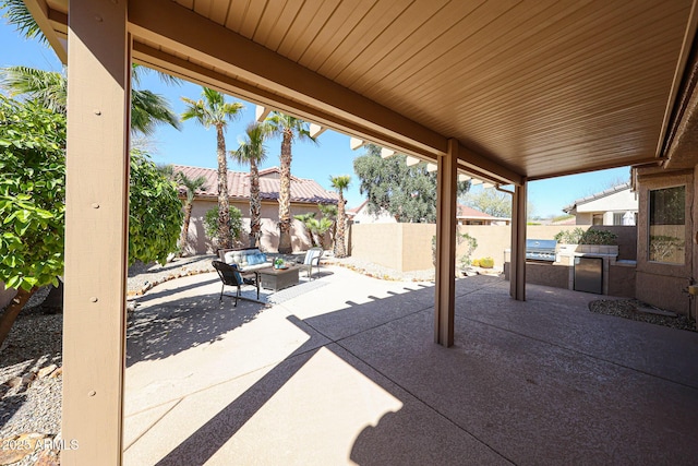 view of patio with area for grilling, a fenced backyard, and an outdoor living space