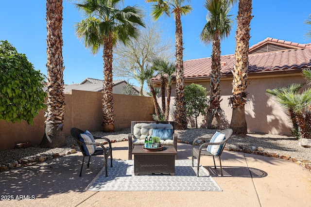 view of patio / terrace featuring outdoor lounge area and fence