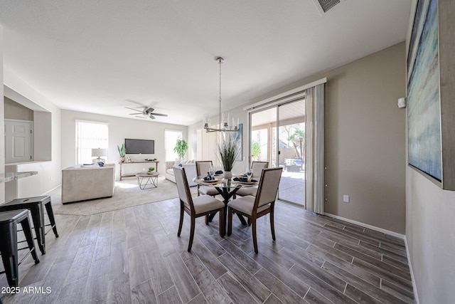 dining room featuring wood finished floors, visible vents, and a healthy amount of sunlight