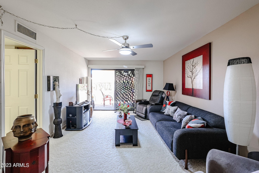 living room featuring ceiling fan and light colored carpet