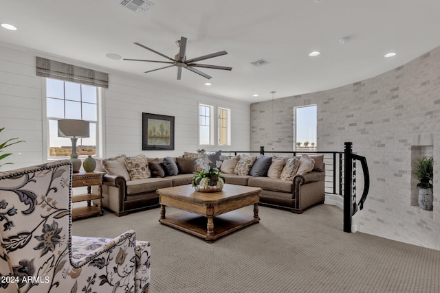 carpeted living room featuring ceiling fan