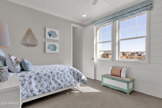 bedroom with carpet floors, crown molding, and multiple windows