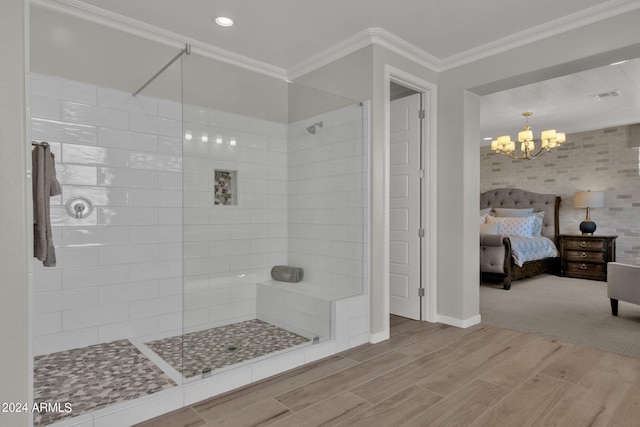 bathroom featuring a tile shower, ornamental molding, and an inviting chandelier