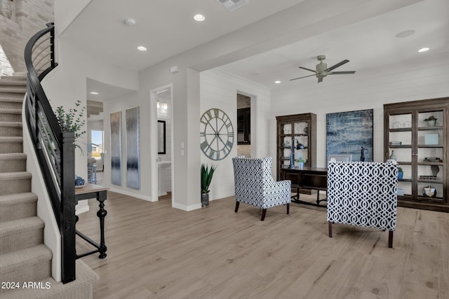 living area with ceiling fan and light hardwood / wood-style floors