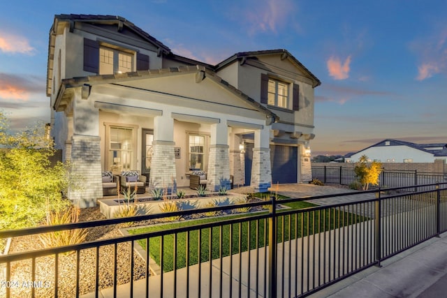 view of front of property featuring a garage and a porch