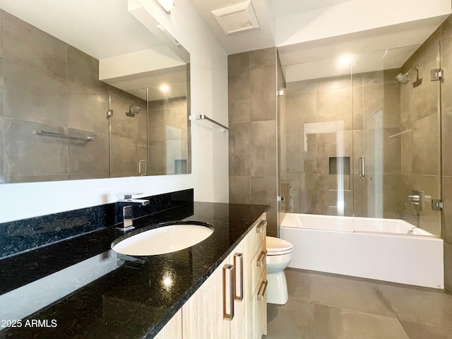 full bath featuring vanity, visible vents, bath / shower combo with glass door, tile patterned flooring, and toilet