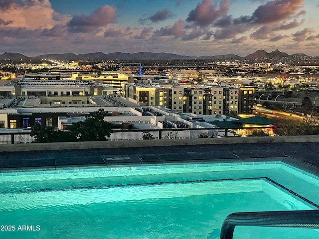 view of pool featuring a mountain view and a view of city