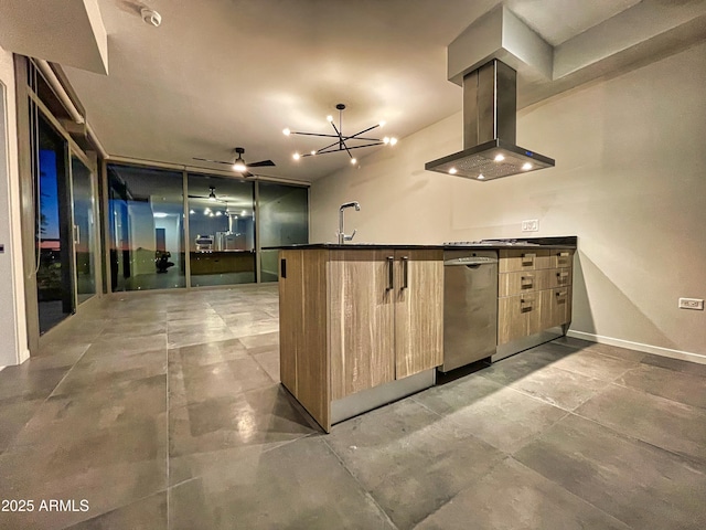 kitchen with light brown cabinets, a ceiling fan, dark countertops, island range hood, and baseboards