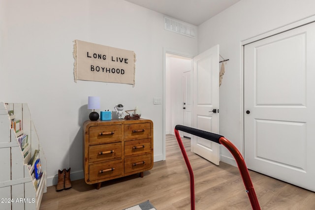 interior space with baseboards, light wood-style flooring, and visible vents