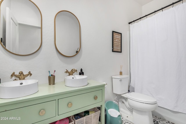 bathroom featuring double vanity, shower / tub combo, toilet, and a sink