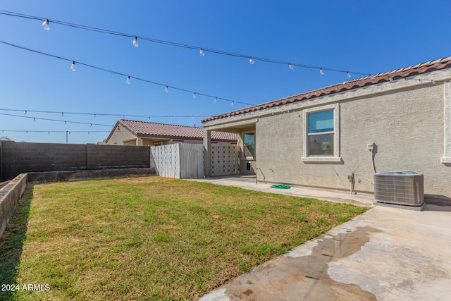 view of yard featuring central air condition unit, a patio area, and a fenced backyard