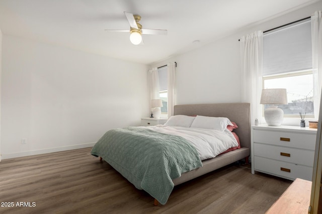 bedroom with wood finished floors, a ceiling fan, and baseboards