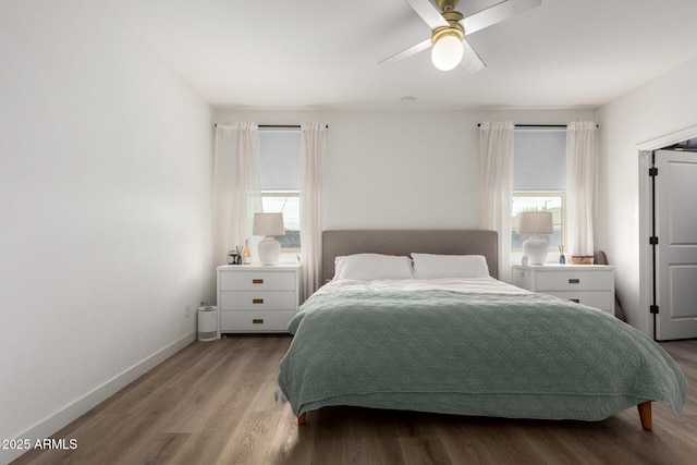 bedroom featuring wood finished floors, a ceiling fan, and baseboards