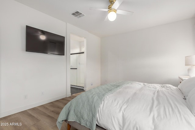 bedroom with wood finished floors, connected bathroom, ceiling fan, baseboards, and visible vents