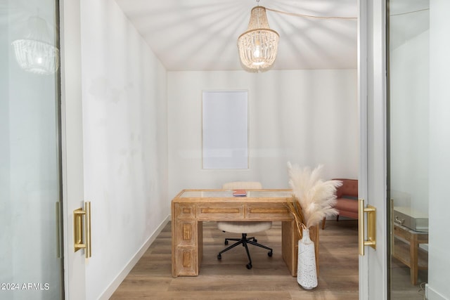 office area with an inviting chandelier and wood finished floors