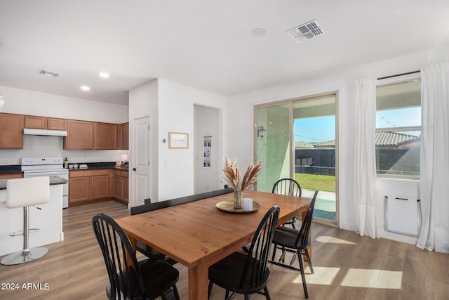 dining room with light wood-style flooring, visible vents, and recessed lighting