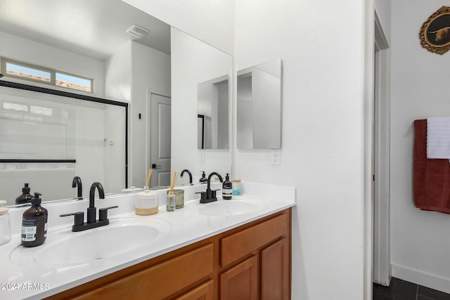 full bath featuring tile patterned floors, a shower with shower door, a sink, and double vanity