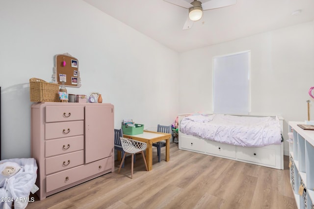 bedroom with a ceiling fan and light wood-type flooring