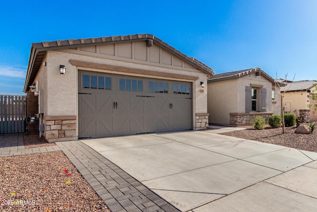 17311 W Seldon Ln, Waddell, AZ 85355 - view of front of home with a garage, driveway, stucco siding, and stone siding