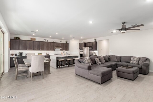 17311 W Seldon Ln, Waddell, AZ 85355 - living room with light wood-style flooring, ceiling fan, and recessed lighting