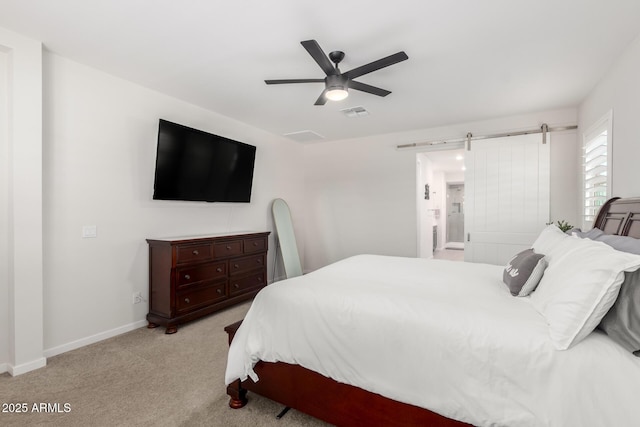 17311 W Seldon Ln, Waddell, AZ 85355 - carpeted bedroom featuring a barn door, baseboards, and a ceiling fan