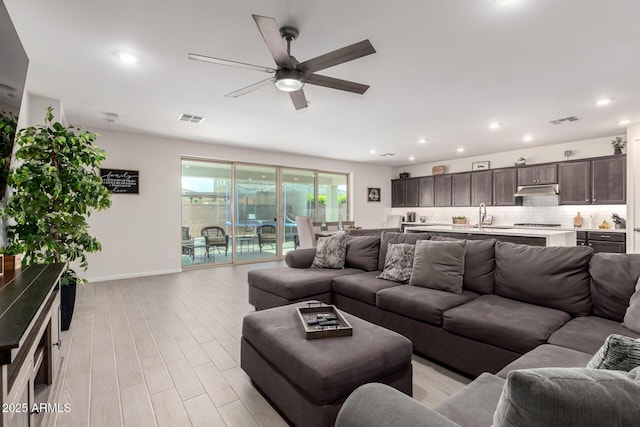 17311 W Seldon Ln, Waddell, AZ 85355 - living area with a ceiling fan, light wood-type flooring, baseboards, and recessed lighting