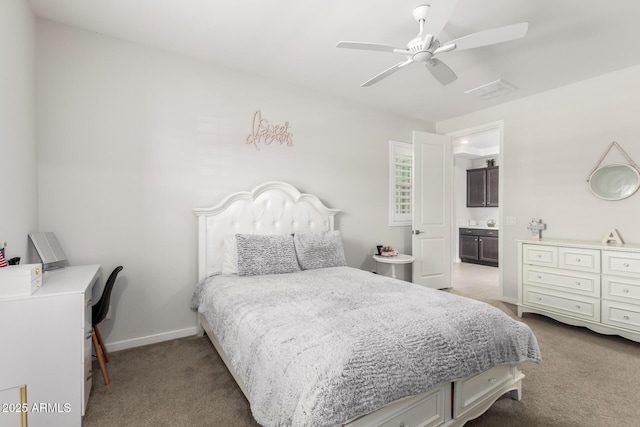 17311 W Seldon Ln, Waddell, AZ 85355 - carpeted bedroom featuring baseboards, ensuite bath, a ceiling fan, and a desk