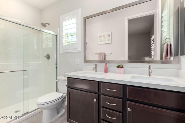 17311 W Seldon Ln, Waddell, AZ 85355 - bathroom with toilet, a stall shower, and double vanity