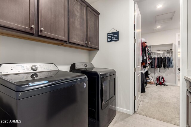 17311 W Seldon Ln, Waddell, AZ 85355 - laundry room featuring cabinet space, washer and clothes dryer, attic access, baseboards, and light carpet