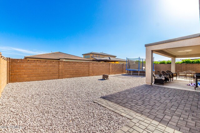 17311 W Seldon Ln, Waddell, AZ 85355 - view of patio / terrace featuring a fenced backyard and a trampoline