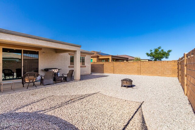 17311 W Seldon Ln, Waddell, AZ 85355 - view of patio with a fenced backyard and a fire pit