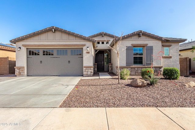 17311 W Seldon Ln, Waddell, AZ 85355 - craftsman inspired home with concrete driveway, an attached garage, a tile roof, stucco siding, and stone siding