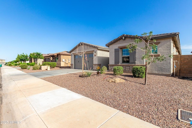 17311 W Seldon Ln, Waddell, AZ 85355 - craftsman-style house with stucco siding, driveway, a tile roof, an attached garage, and a residential view